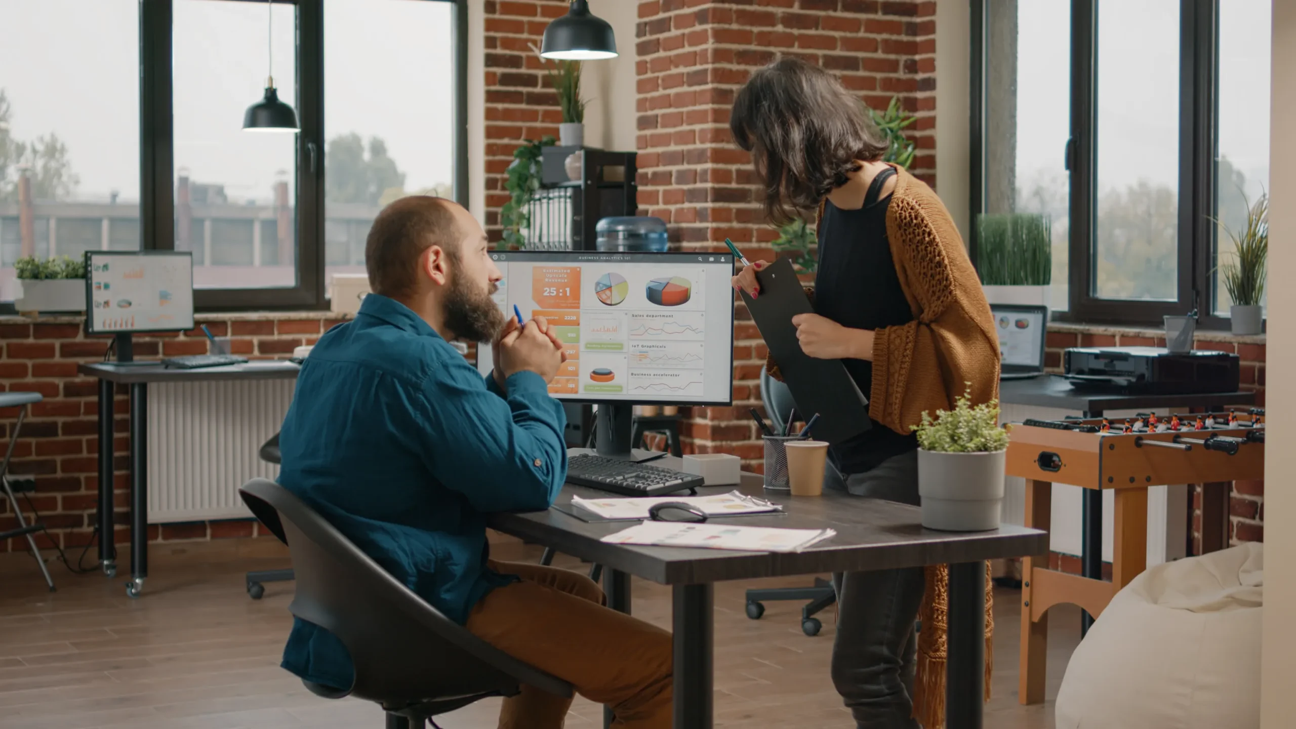 Business man asking help from woman design rate charts computer monitor entrepreneur colleagues doing teamwork plan data analysis display startup presentation